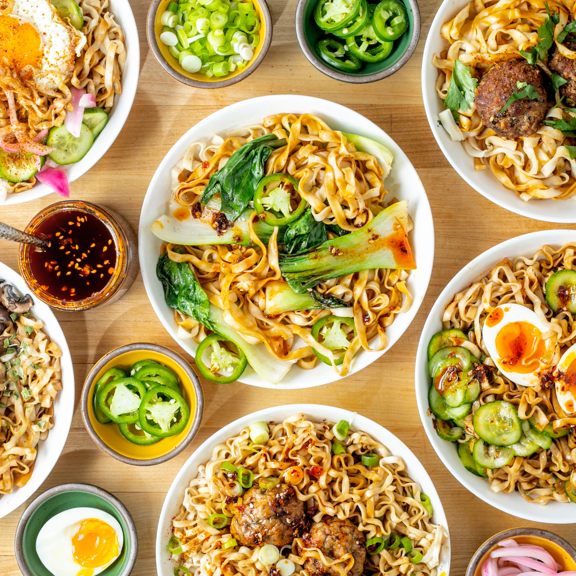 Prepared A-Sha noodle dishes with fresh toppings